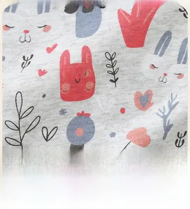 Detailed close-up of grey knitted fabric with cute cartoon rabbit and heart patterns