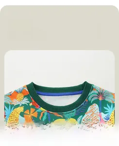 Close-up of boys crew neck sweatshirt with green ribbed collar and tropical rain forest print