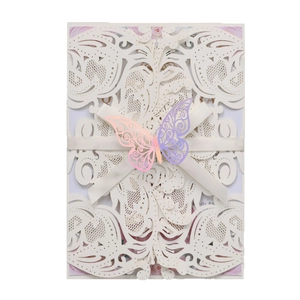 Laser cut ivory wedding invitation featuring a purple butterfly and satin ribbon accent