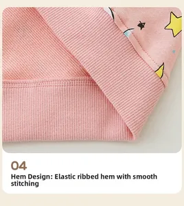 Close-up of pink hoodie hem with elastic ribbed cuff and yellow star pattern detail
