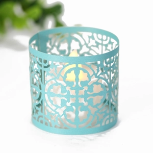 Close-up of light blue hollow paper lantern with warm LED light glow for party decor