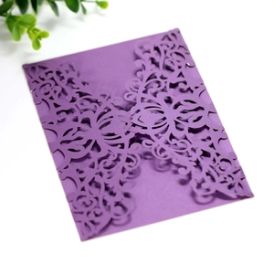 Detail of laser-cut floral pattern on elegant deep purple wedding invitation card