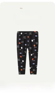 Close-up of girls' black Halloween leggings with pumpkins, ghosts, and cats prints