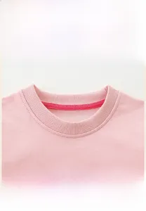 Detail of pink cotton sweatshirt neckline with ribbed collar and reinforced hot pink tape
