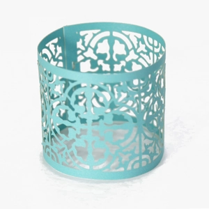Detailed close-up of light blue hollowed paper lampshade with laser cut floral patterns