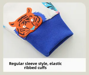 Detail view of boys' sweatshirt with tiger print and blue elastic ribbed cuffs