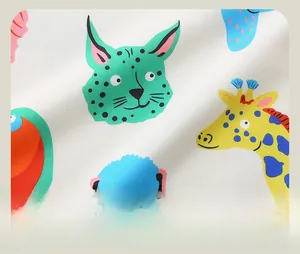 Detailed view of soft cotton fabric with colorful cartoon animal print for kids sweatshirt