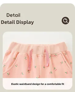 Detail of pink cotton shorts with cherry print and elastic drawstring waistband