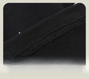 Detailed close-up showing precise triple-needle stitching on black knitted fabric hem