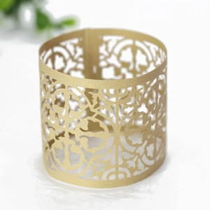 Detailed view of hollow golden paper sleeve with intricate European laser cut patterns