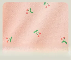 Detail of light pink knit fabric featuring cute cherry prints for girls sweatpants