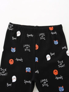 Kids Halloween leggings featuring ghost and pumpkin prints on soft black cotton fabric