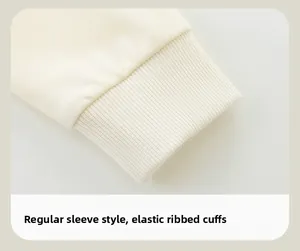 Detail of soft beige sweatshirt showing elastic ribbed cuffs and sleeve stitching