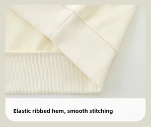 Detail of high-density ribbed elastic hem and smooth stitching on cream toddler sweatshirt