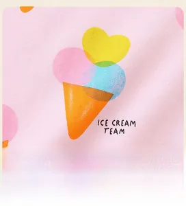 Detail of pink cotton knit fabric featuring a cute colorful ice cream team graphic print