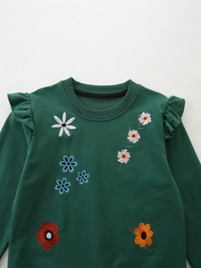 Dark green girls sweatshirt with ruffled shoulders and colorful floral embroidery details