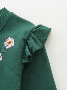 Dark green girls sweatshirt with ruffled shoulders and delicate floral embroidery details