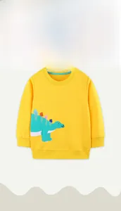 Detail of yellow cotton sweatshirt with green dinosaur patch and blue neck piping