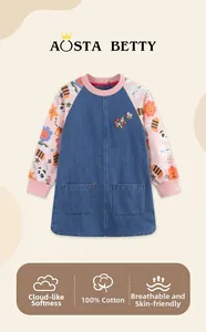 Detail of 100% cotton denim girls smock dress with cartoon print sleeves and embroidery