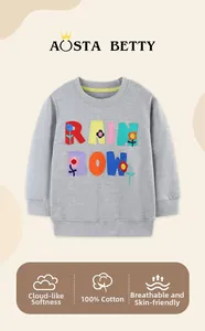 Detail of gray girls sweatshirt featuring 3D rainbow patch and floral embroidery