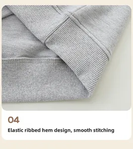 Detailed macro view of the elastic ribbed hem and neat stitching on a grey girl's sweatshirt