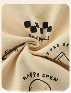 Close-up of soft beige knit fabric with checkerboard and smiley face patterns