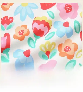 Close-up of strawberry and flower patterns on twill cotton sweatshirt fabric