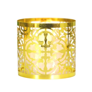 Golden hollow metal candle holder with intricate laser-cut patterns for festive decor