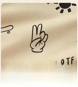 Detail of cotton hoodie showing skate and sun print with skate lettering on yellow fabric