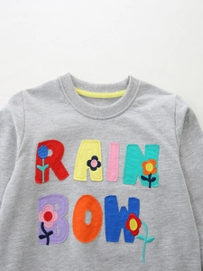 Grey girls' sweatshirt with rainbow letter patches and colorful embroidered flowers