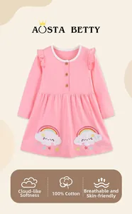 Detail of pink cotton girl dress with wooden buttons and rainbow embroidery