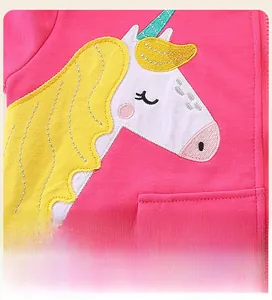 Close-up of cute unicorn embroidery patch on pink girls hoodie with detailed stitching