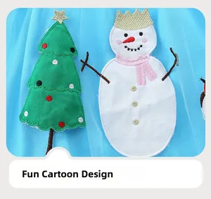 Close-up of blue tulle dress with snowman and Christmas tree embroidery details