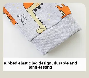 Detail of ribbed elastic cuffs on grey boys' joggers with cartoon dinosaur print