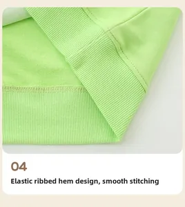 Detailed close-up of light green knitted cotton sweatshirt with elastic ribbed hem and stitching