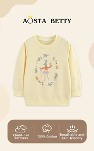 Detail of light yellow cotton sweatshirt with a cute rabbit illustration and soft texture