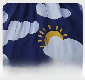 Detail of dark blue mesh fabric featuring cartoon white clouds and yellow sun patterns