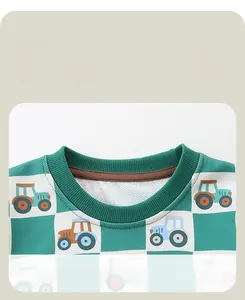 Close-up of comfortable ribbed round neck and plaid tractor pattern on kid sweater