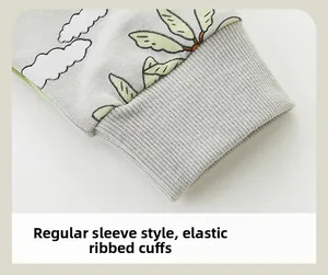 Detailed close-up of light grey kids sweatshirt with elastic ribbed cuffs and dinosaur prints