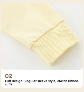 Detail shot of light yellow elastic ribbed cuffs on a cotton knit sweatshirt for girls