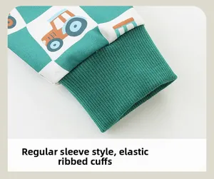 Detail of green checkerboard sleeve with cartoon tractor print and ribbed elastic cuffs