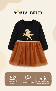 Detail of girls' dress featuring 100% cotton top with horse print and orange mesh tutu skirt
