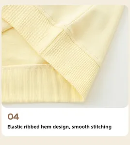 Close-up of the elastic ribbed hem and neat stitching on this yellow cotton sweatshirt
