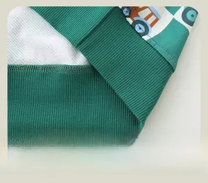 Detail of green ribbed hem with cartoon tractor print and premium stitching on kids hoodie