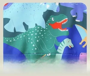Detail of soft knit fabric with colorful dinosaur prints and ribbed hem on kids sweatshirt
