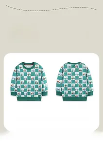 Detail view of boys checkered sweatshirt with colorful tractor prints and green ribbed cuffs