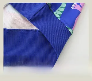 Detail shot of the elastic ribbed hem on a blue dinosaur sweatshirt with clean stitching