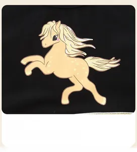 Detail of cute yellow cartoon pony print on high-quality black mesh girls dress fabric