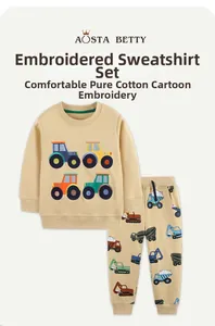 Detail of cartoon tractor embroidery on beige cotton sweatshirt and printed pants