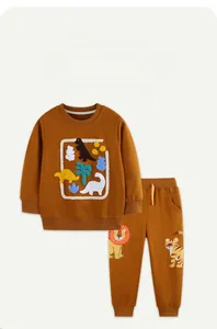 Detail of ginger cotton kids sweatshirt set featuring 3D dinosaur embroidery and lion prints